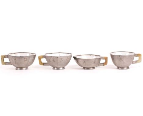 Four Chinese pewter, jade and Yixing teacups, Qing, late 19th century, the Yixing body encased in pewter with a jade handle, 