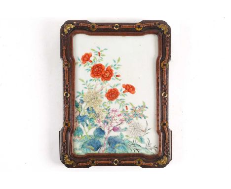 A Chinese porcelain panel, Qing,19th century, painted with blossoming peony and chrysanthemums, mounted in a hardwood frame i