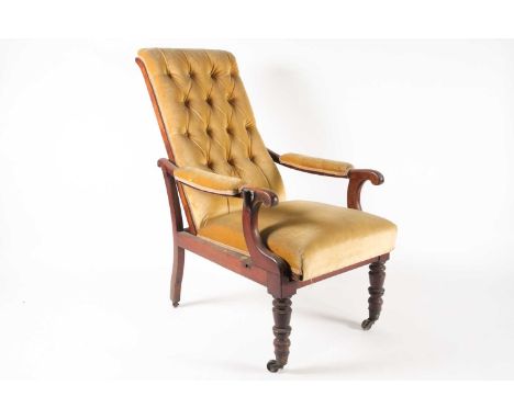 An early Victorian mahogany reclining library armchair with scroll arms with reading rest bracket (no rest present),  buttone