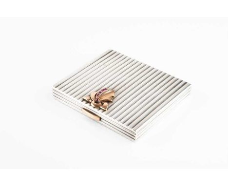 A French Art Deco powder compact of rectangular form,  in ribbed white metal (tests as silver), with applied gold and ruby de