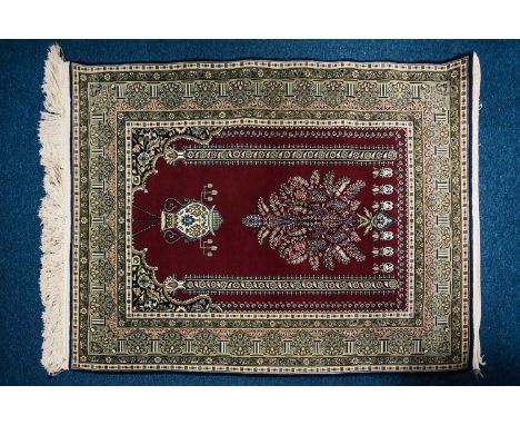 A 20th century finely knotted Turkish (possibly Hereke) prayer rug with lobed mihrab with the flowering censer and hanging la