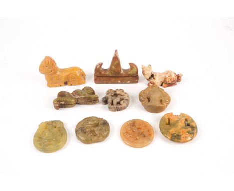 A collection of ten Chinese carved and pierced hardstone objects including, pen rest, amulets archaic style animal figures, a