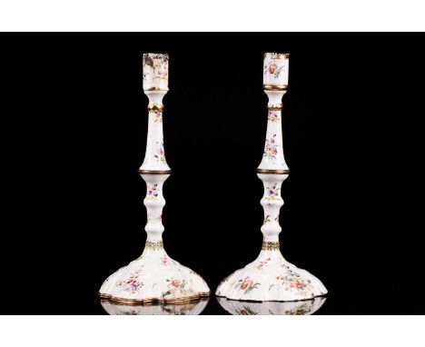 A pair of 18th century Bilston or Battersea enamel table candlesticks. With knopped columns and molded domed bases. Painted w