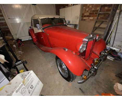 A 1953 red MG TD motor car, Registration: NLO 517. Barn find. 1250cc. Odometer showing 58,464 miles. Currently SORN'd.VIN: TD