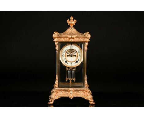 A 20th century gilt metal four-glass mantel clock, striking on a coil gong, in ornate case with urn finial, the enamel dial b