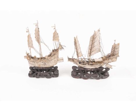 Two Chinese silver models of junks, circa 1900, the taller example marked for Tien Shing, the longer boat with five cannons a