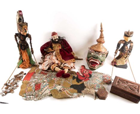 Three Balinese puppets, a large shadow puppet, a carved wood table box, 21.5cm wide, and a lacquered card dragon mask