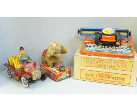 A tin plate Mettype Junior typewriter, boxed and two 1940s Japanese tin plate toys, Smokey Bill and Jumbo The Bubble Blowing 