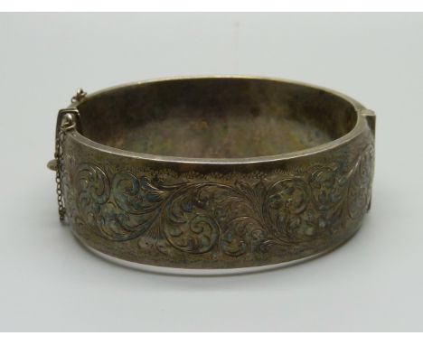 A hallmarked silver bangle, dented on the back, 36g 