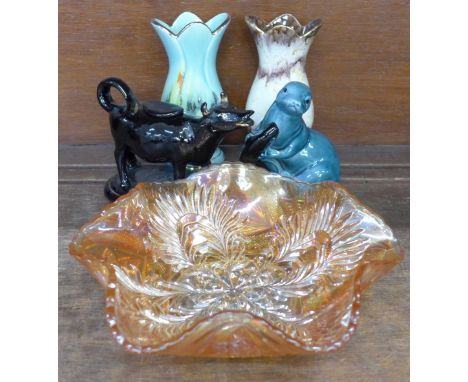 A 19th century cow creamer, two 1950s vases, a Poole Pottery seal and an orange carnival glass bowl 