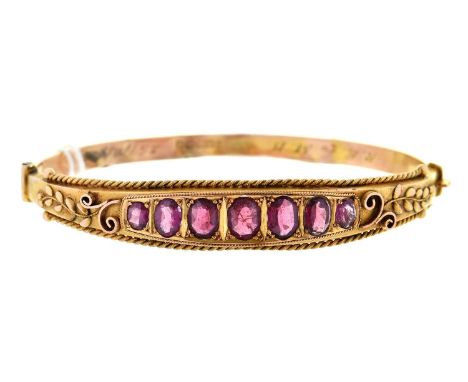 An amethyst bangle, in 9ct gold, Birmingham 1910, 8.6g  Lower half damaged from wear