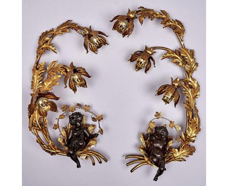 A pair of bronze and giltmetal three light wall sconces, of leafy naturalistic design curling to form a bower for the bronze 