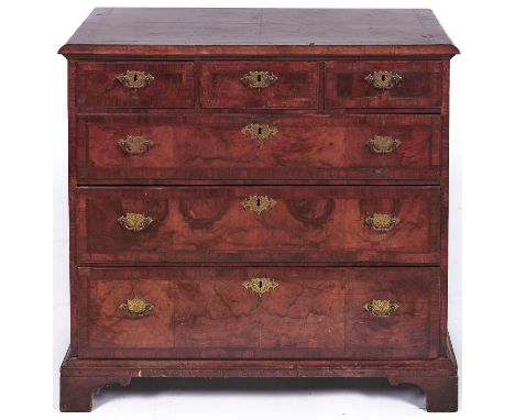 A George II walnut and feather banded chest of drawers, having quarter veneered top and fitted three short and three graduate