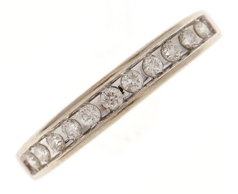 A diamond ring,&nbsp; with line of eleven round brilliant cut diamonds, in white gold marked 18, 2.9g, size O  Slight wear