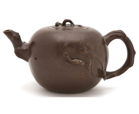 A Chinese Yixing stoneware teapot, cover and infuser,&nbsp;&nbsp; globular with foliage and branch issuing from the gnarled s