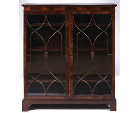 A mahogany bookcase, early 20th c, in George III style, enclosed by glazed doors, bracket feet, adjustable shelves, 122cm l, 