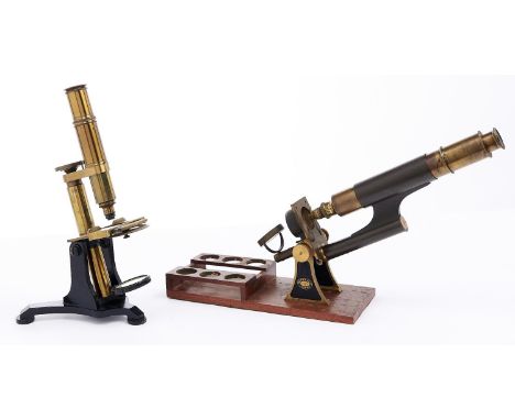 A brass and black painted iron compound microscope, late 19th c, the limb on trunnions between shaped side plates with microm