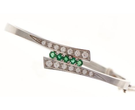 An emerald and diamond bangle, in white gold, 64mm, marked 750, 19.8g  Good condition