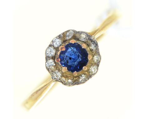 A sapphire and diamond cluster ring, early 20th c, in gold marked 18ct, 2.3g, size O  Wear consistent with age