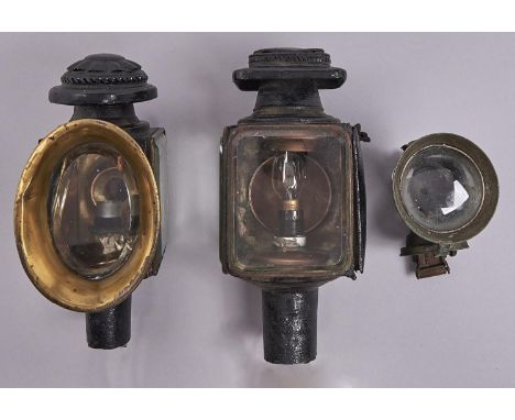 Two Victorian black japanned carriage lamps, brass mounts, re-painted, lacks shaft, adapted for electricity and a brass acety