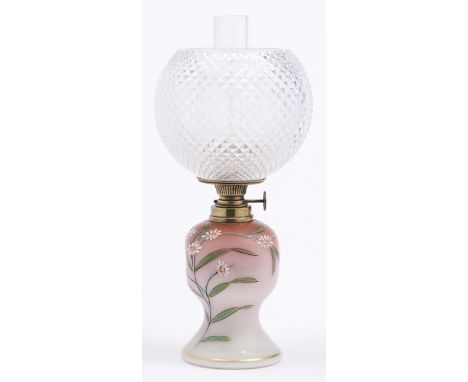 An enamelled shaded pink satin glass oil lamp, c1890, with German brass burner and a cut glass globe, 24cm h excluding chimne