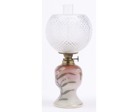 An enamelled shaded pink satin glass oil lamp, c1890, with German brass burner and a cut glass globe, 24cm h excluding chimne