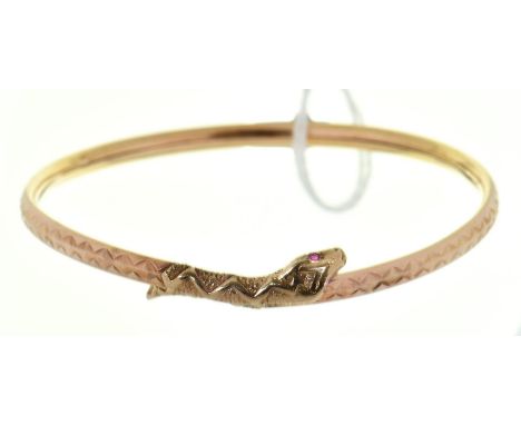 A gold snake bangle with ruby eyes, 5.8g  Slight dents