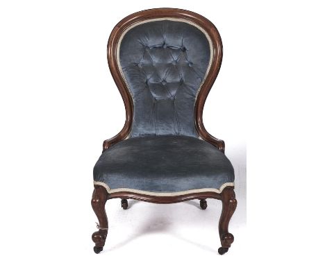 A Victorian mahogany nursing chair, c1870, with moulded frame, the button back and stuffed over serpentine seat in blue drayl