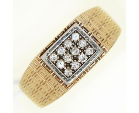 A diamond ring, in gold with textured shoulders marked 585, 6.4g, size T  Hoop flattened from wear on underside