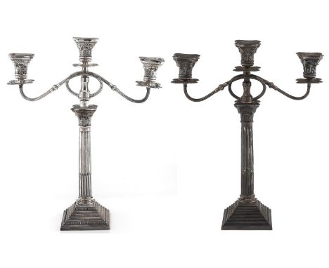 A pair of George V silver columnar candelabra&nbsp;of three light, with Corinthian capitals, beaded drip pans and reeded scro