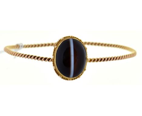 A gold bangle, mounted with earlier associated Victorian banded agate cabochon, 9.2g  Good condition