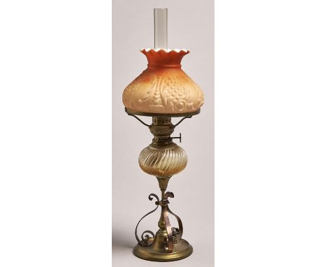 A brass and copper oil lamp, late 19th c, with spirally reeded glass fount and German brass burner, shaded coral satin glass 