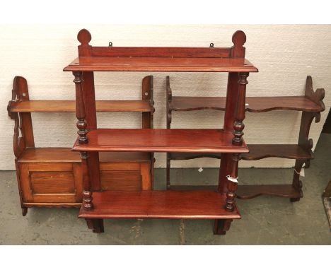 A Victorian mahogany three tier hanging wall shelf, with turned pillars, 86cm h; 60cm w and two oak hanging wall shelves, one