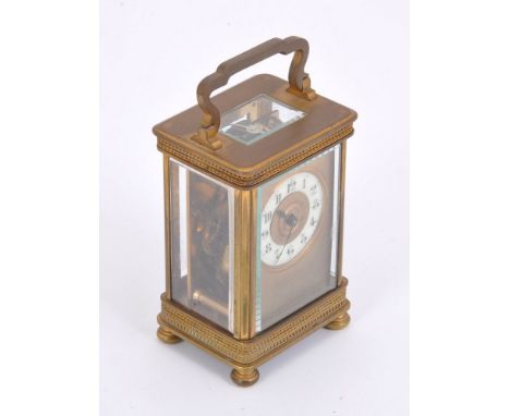 A brass carriage clock, bimetallic split balance, flat balance spring, lever escapement, the dial with Arabic numerals, blued