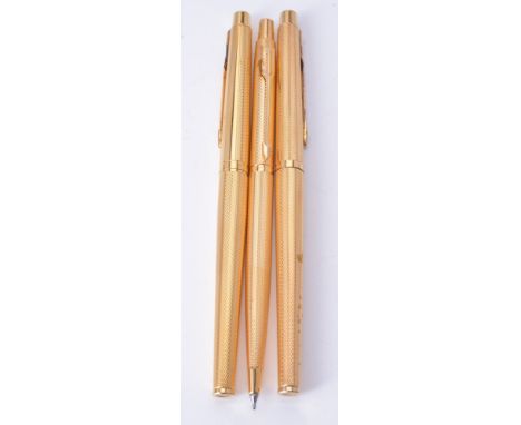 Parker, Classic Grain D'orange, a gold plated fountain pen, roller ball pen and propelling pencil, the fountain pen with arro