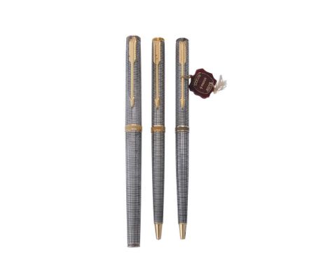 Parker, Premier Cisele, two silver coloured ball point pens and a roller ball pen, with gilt arrow clips and stamped with Fre