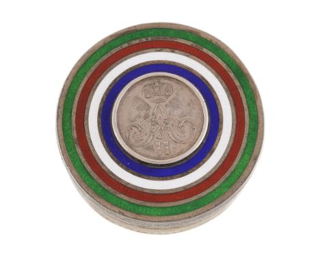 An Edwardian silver parcel gilt and enamel circular box by King &amp; Sons, Chester 1902, the cover inset with a Russian jett