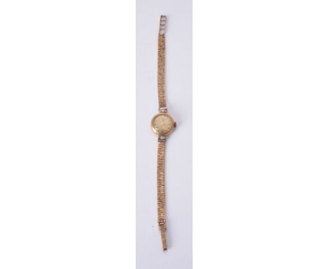 Tissot,   Lady's gold and diamond bracelet watch, no. 10035, circa 1960   Movement: Manual wind, 15 jewels   Case: Gold colou