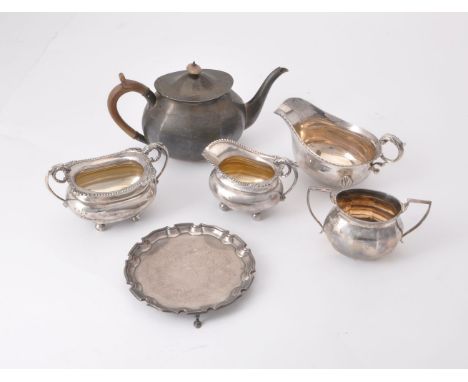 A collection of silver, including: an panelled oval tea pot and sugar basin by Thomas Bradbury &amp; Sons Ltd, Sheffield 1924