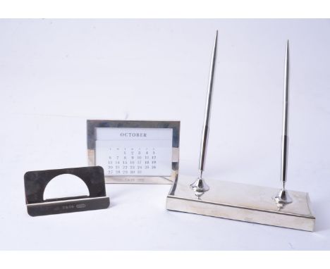 A silver mounted desk set by Tiffany &amp; Co., to include: a double pen stand, stamped 925, the rectangular base with two pe