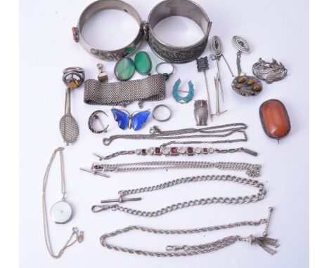 A collection of silver set jewellery including an opal and garnet bracelet, a garnet crescent brooch, a tennis raquet and oth