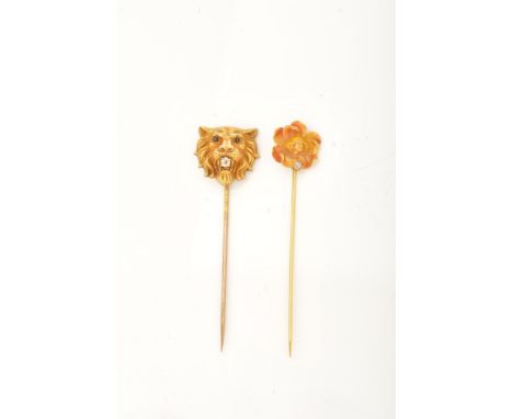 Two stickpins: - A 19th century gold hollow lion mask stickpin, the head realistically modelled, with an old-cut diamond to t