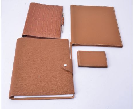 Hermes, a brown pebble grain leather notepad case, with a button fastener, 23cm high; Hermes, a brown leather note pad case, 