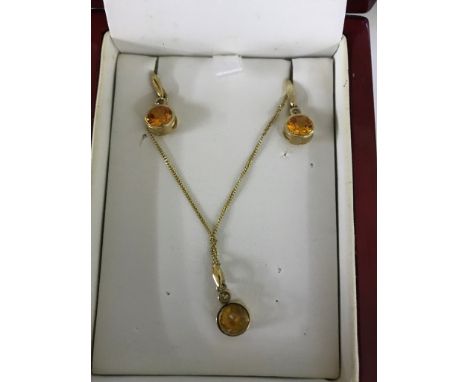 A fire opal earring and pendant set