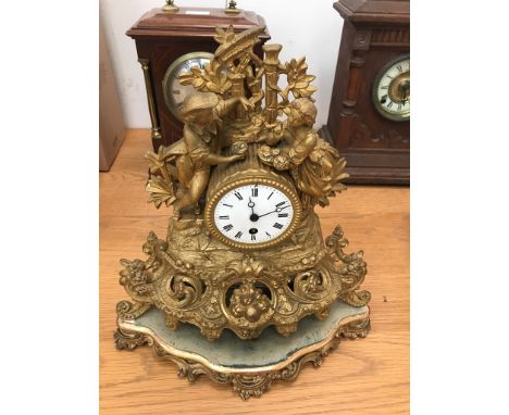 A 19th century spelter mantel clock on stand with matching pendulum and movement