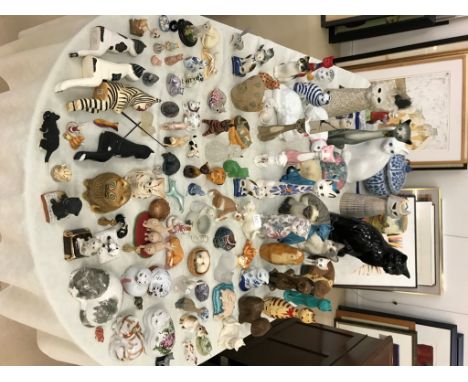 A large quantity of ceramic and resin cat figurines