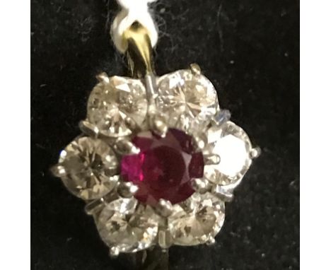 An 18ct diamond and ruby cluster ring, central brilliant cut ruby, spreads as 0.90ct