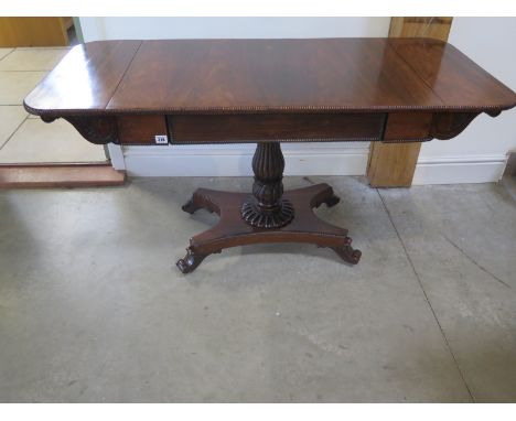 A 19th century rosewood sofa table with drop end flaps on a carved column and quatrefoil platform base in restored condition 