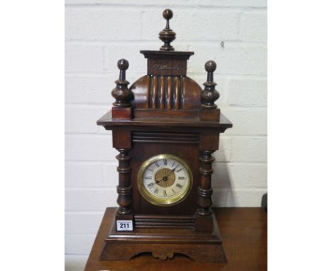 An oak case mantle clock with musical alarm 