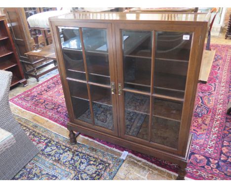 A circa 1920's oak cabinet bookcase with adjustable shelves - 107cm x 29cm x 123cm high 